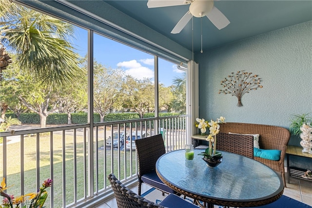 sunroom / solarium featuring ceiling fan