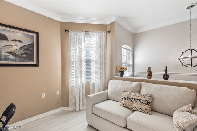 living area with a notable chandelier, baseboards, and ornamental molding