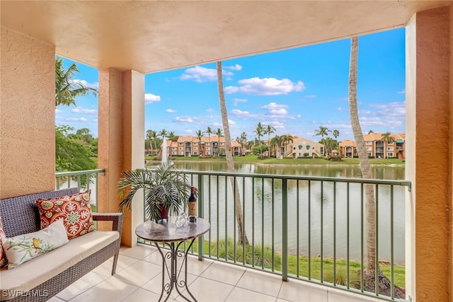 balcony with a residential view and a water view