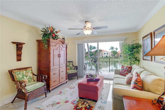 living area featuring a textured ceiling, ornamental molding, and ceiling fan