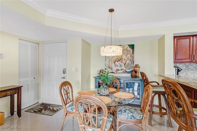 dining space featuring crown molding