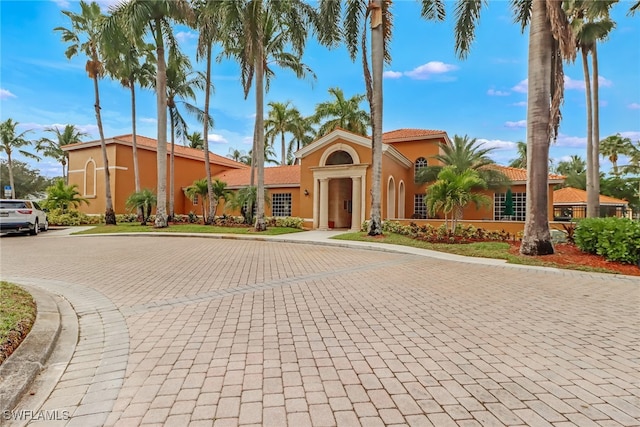 view of building exterior with curved driveway