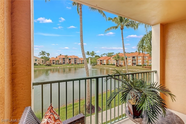 balcony featuring a residential view and a water view