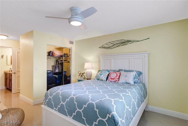 bedroom with a closet, visible vents, baseboards, and light tile patterned floors