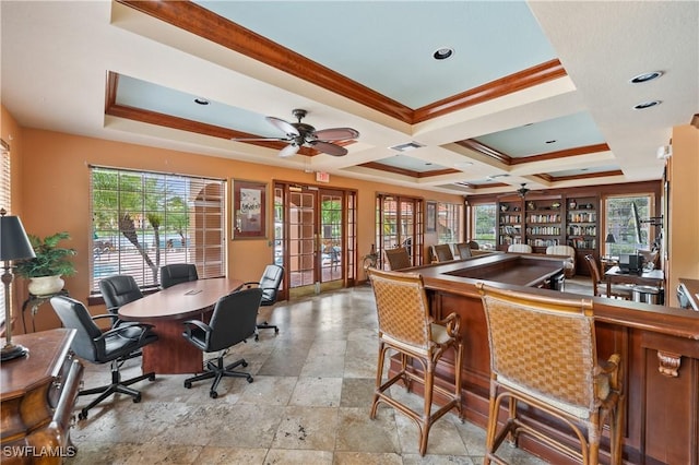 interior space featuring ornamental molding, a tray ceiling, stone tile floors, french doors, and ceiling fan