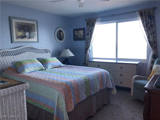 bedroom featuring multiple windows, ceiling fan, and carpet flooring