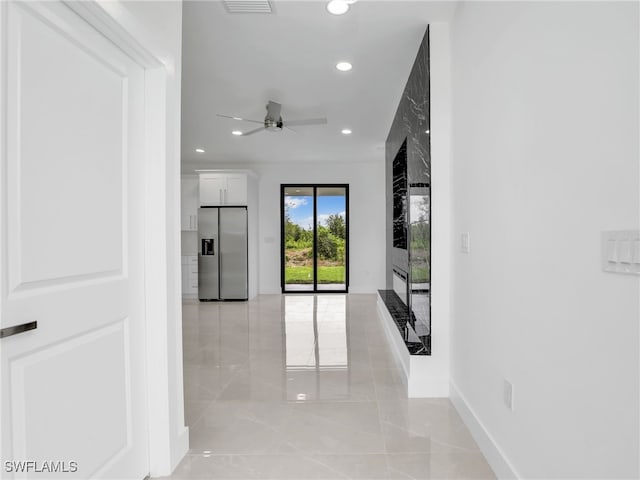 hall featuring visible vents, recessed lighting, baseboards, and marble finish floor