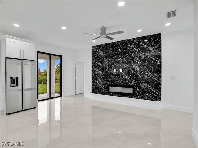 interior space with visible vents, an accent wall, recessed lighting, marble finish floor, and a ceiling fan