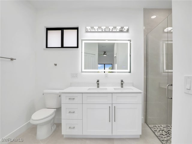 full bath with vanity, toilet, baseboards, and a stall shower