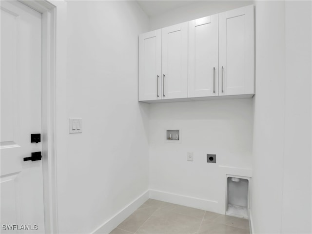 laundry room featuring baseboards, light tile patterned floors, hookup for a washing machine, cabinet space, and electric dryer hookup