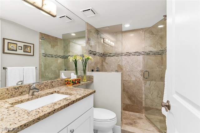 full bathroom featuring visible vents, toilet, a stall shower, and vanity