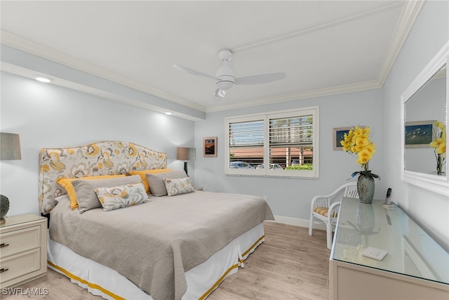 bedroom with crown molding, light wood-style flooring, a ceiling fan, and baseboards