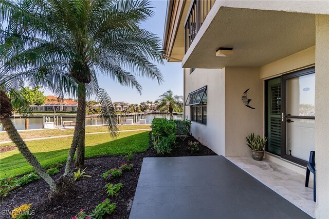 view of yard with a patio area and a water view