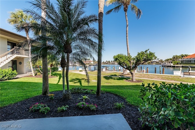 view of community with a lawn and a water view