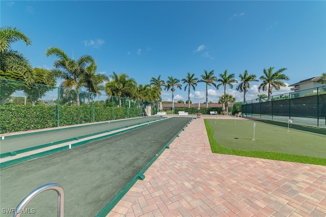 view of home's community featuring fence