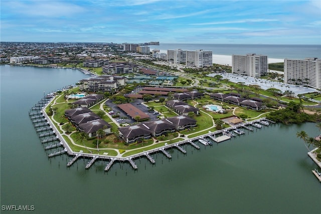 birds eye view of property with a water view and a view of city