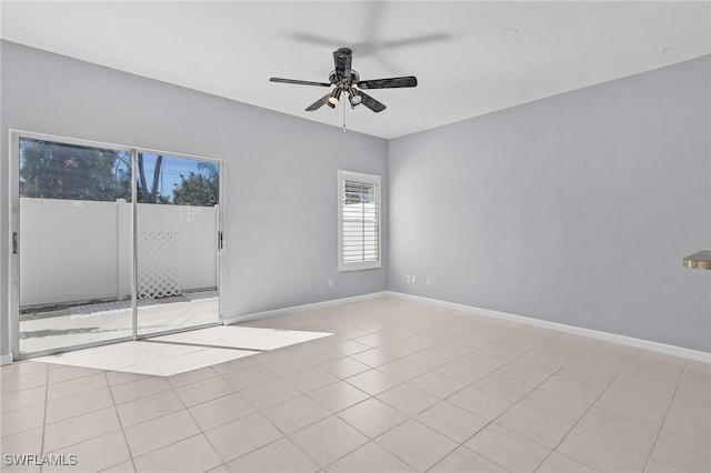 spare room with light tile patterned floors, a ceiling fan, and baseboards