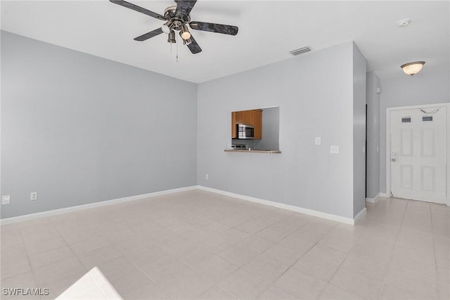 unfurnished room featuring a ceiling fan, baseboards, and visible vents