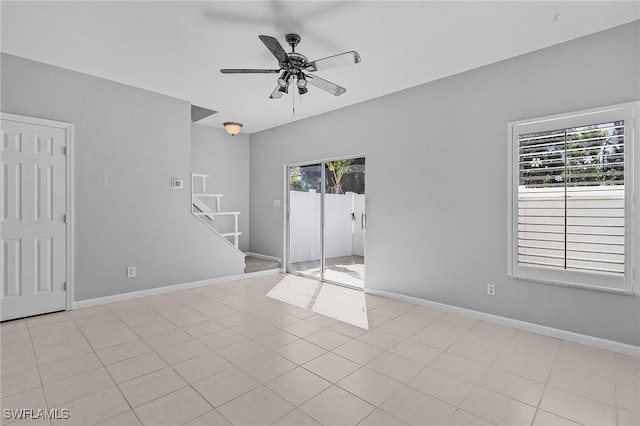 spare room featuring plenty of natural light and baseboards