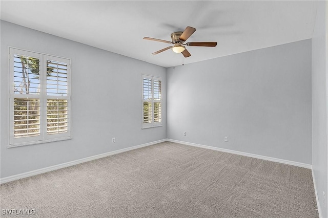 unfurnished room featuring carpet, baseboards, and ceiling fan