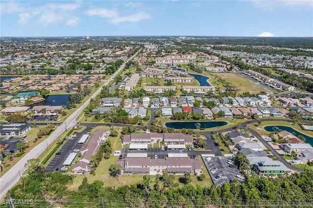 drone / aerial view with a residential view and a water view