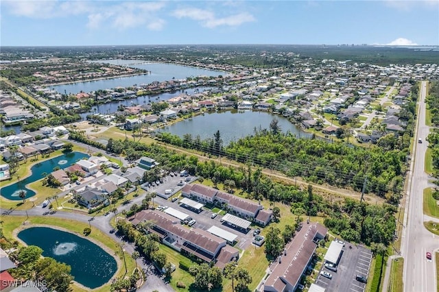 birds eye view of property with a residential view and a water view