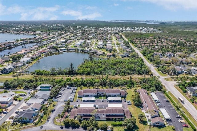 drone / aerial view with a residential view and a water view