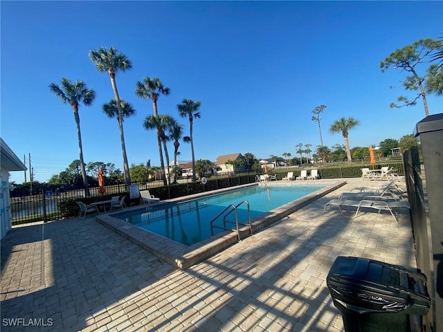 community pool featuring a patio area and fence