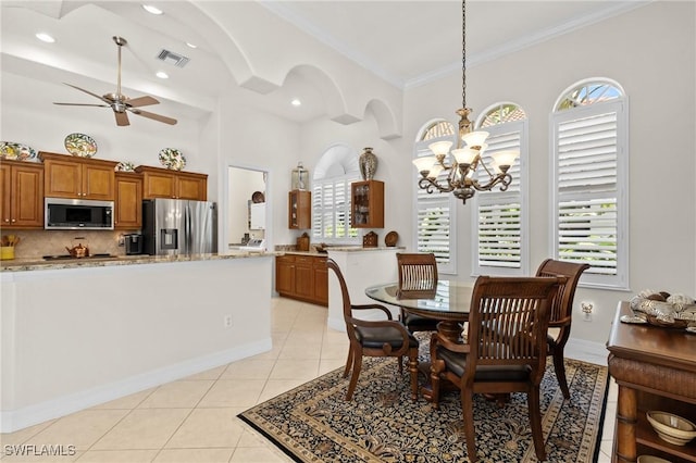 2874 Lone Pine Ln, Naples, FL 34119 - dining space featuring a high ceiling, ceiling fan with notable chandelier, light tile patterned floors, visible vents, and ornamental molding