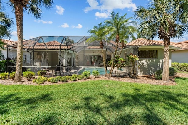 2874 Lone Pine Ln, Naples, FL 34119 - back of house with a lawn, a tiled roof, stucco siding, and an outdoor pool
