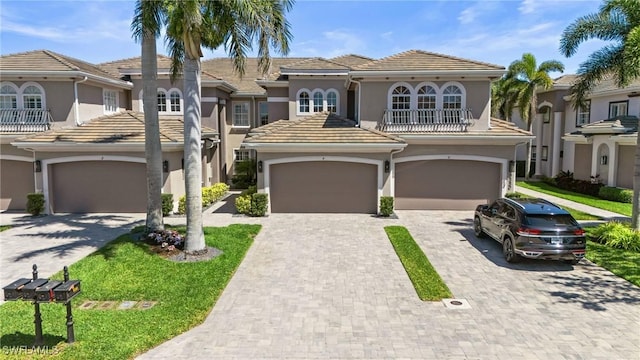9330 Triana Ter Unit 274, Fort Myers, FL 33912 - view of front of property with driveway, a tiled roof, and stucco siding