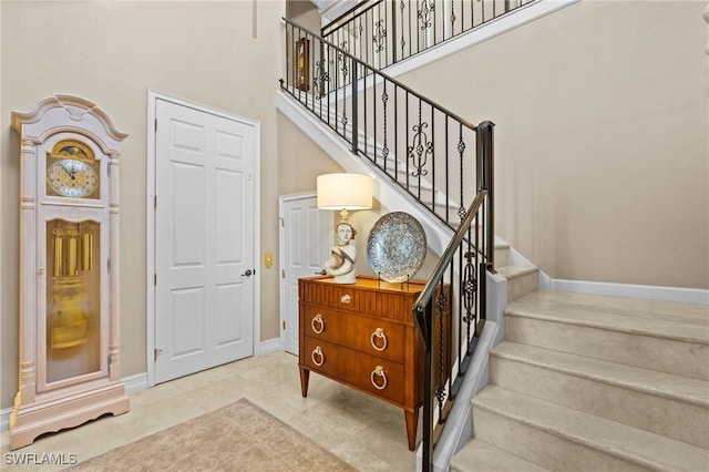 9330 Triana Ter Unit 274, Fort Myers, FL 33912 - staircase featuring baseboards and a towering ceiling