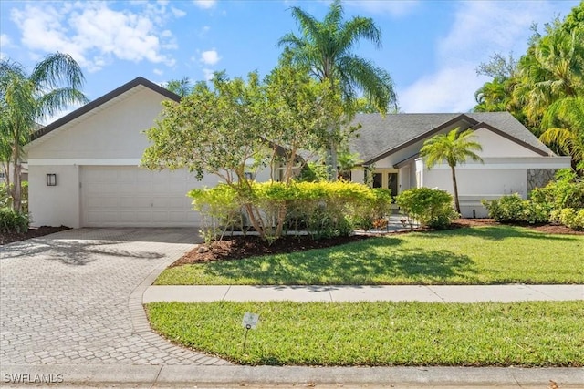 ranch-style home with stucco siding, a front lawn, decorative driveway, and a garage