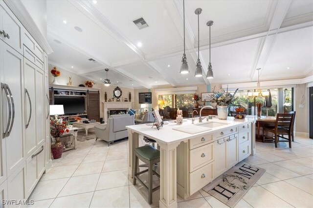 kitchen with light tile patterned floors, visible vents, light countertops, and a sink