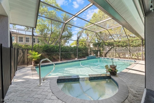 view of pool featuring a lanai, a pool with connected hot tub, a patio, and fence