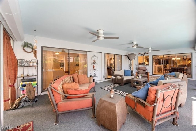 carpeted living room featuring a ceiling fan