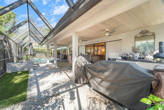 view of patio with an outdoor pool, glass enclosure, a grill, and ceiling fan