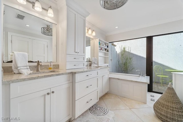 full bath with visible vents, ornamental molding, tile patterned flooring, a bathtub, and vanity