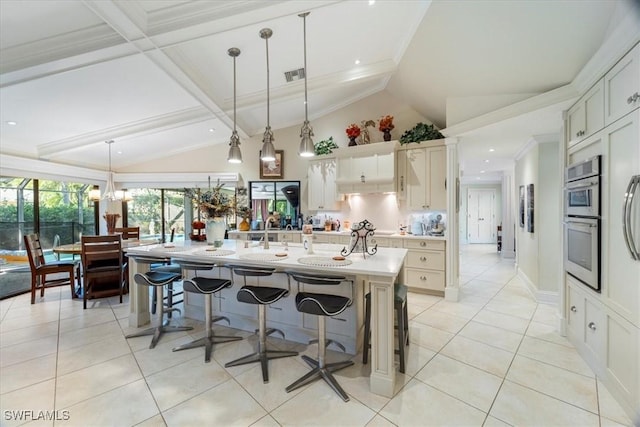 kitchen featuring light countertops, decorative light fixtures, light tile patterned floors, and visible vents