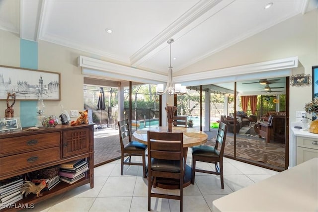 dining room featuring lofted ceiling, ornamental molding, and light tile patterned flooring