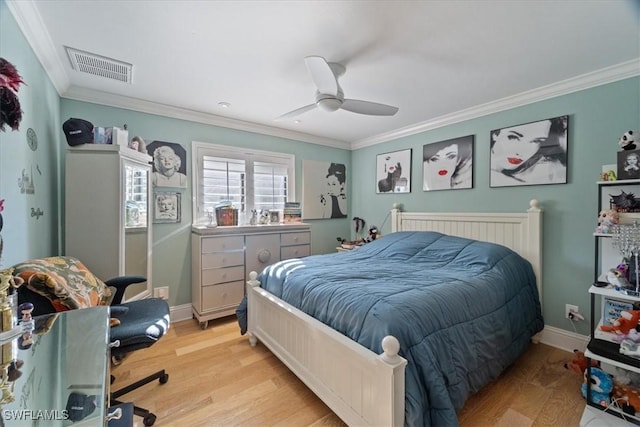 bedroom with visible vents, light wood-style flooring, crown molding, and baseboards