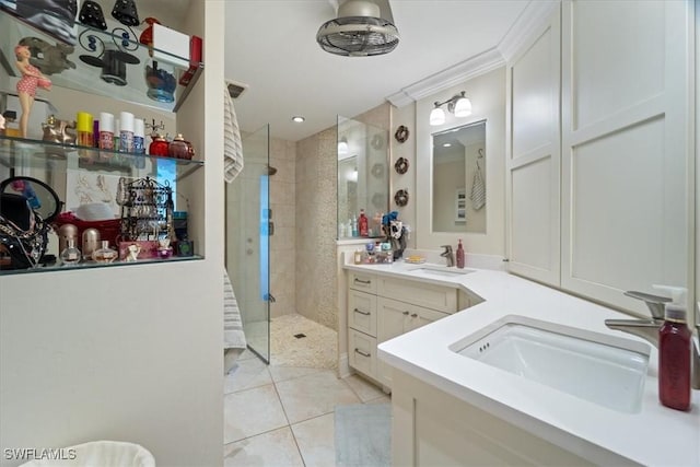 bathroom with tile patterned flooring, crown molding, vanity, and walk in shower