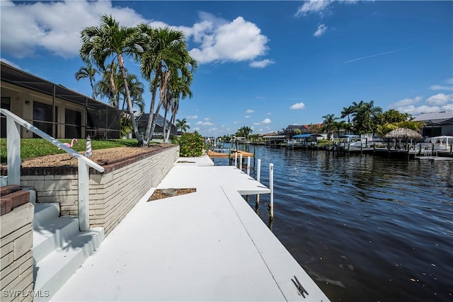 dock area with glass enclosure and a water view