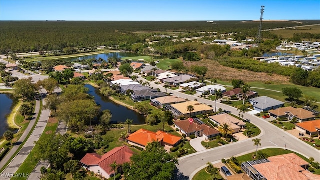 drone / aerial view featuring a residential view and a water view