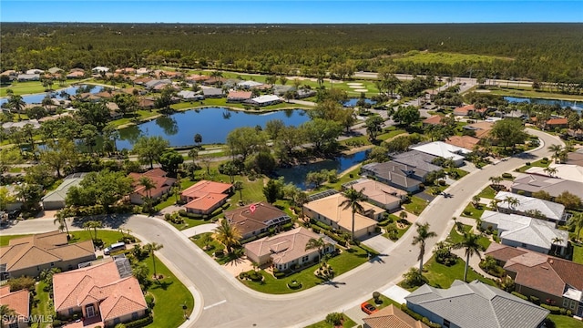 aerial view with a forest view, a residential view, and a water view