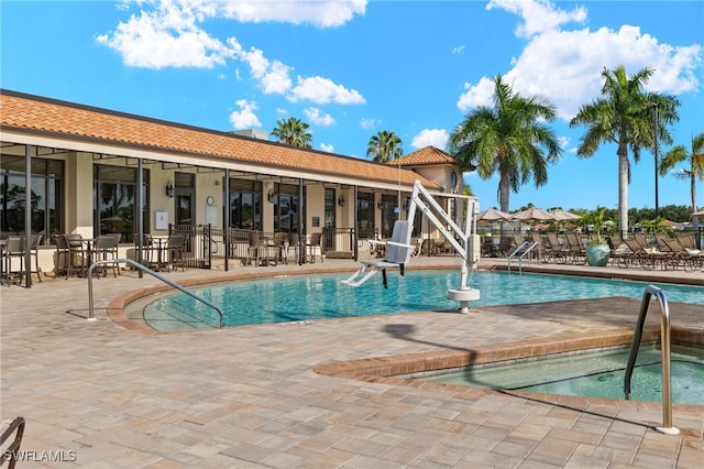 pool featuring a community hot tub and a patio