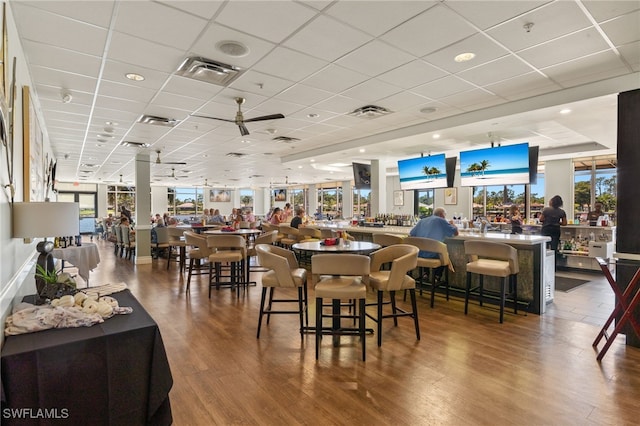 dining area featuring wood finished floors, visible vents, and a paneled ceiling