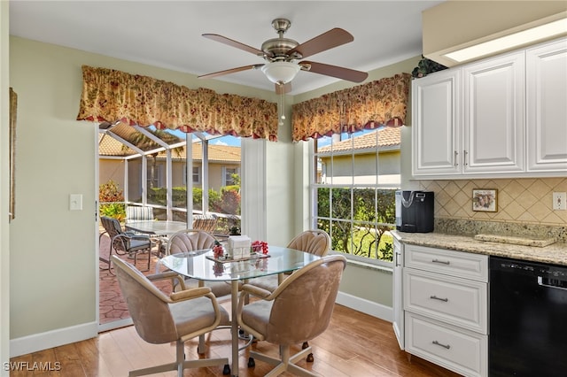 dining space with baseboards, light wood-style floors, and a ceiling fan