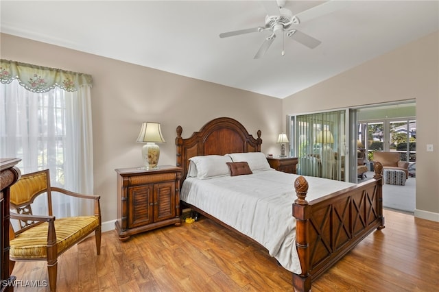 bedroom featuring ceiling fan, baseboards, lofted ceiling, and wood finished floors