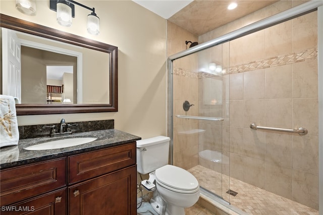 full bathroom with vanity, toilet, and a stall shower